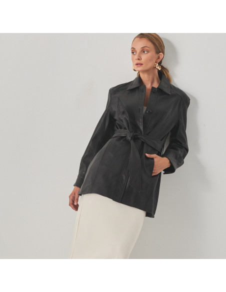 Black leather trench coat, mid shot of model leaning against the wall with perspective view - MONPIEL