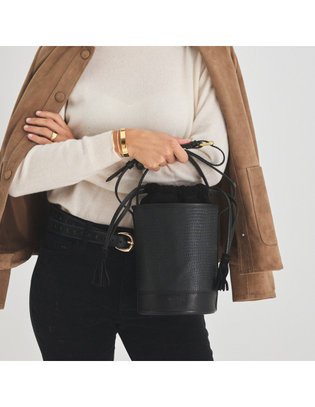 Small round black snakeskin leather bucket bag, front view, held by the handle - MONPIEL
