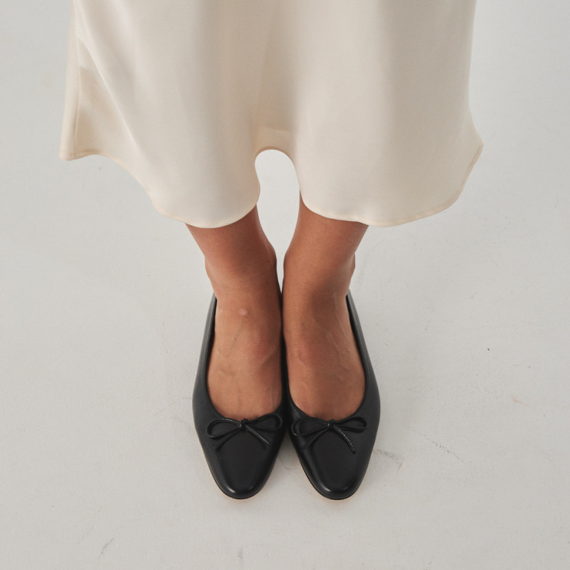 Manolita flat ballerina with stylized toe in black, overhead view close-up - MONPIEL
