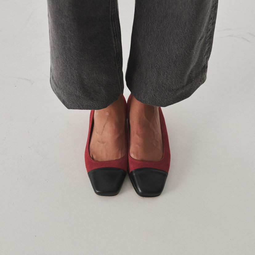 Women's square toe leather shoe in pink suede with black toe, worn by model, overhead view - MONPIEL