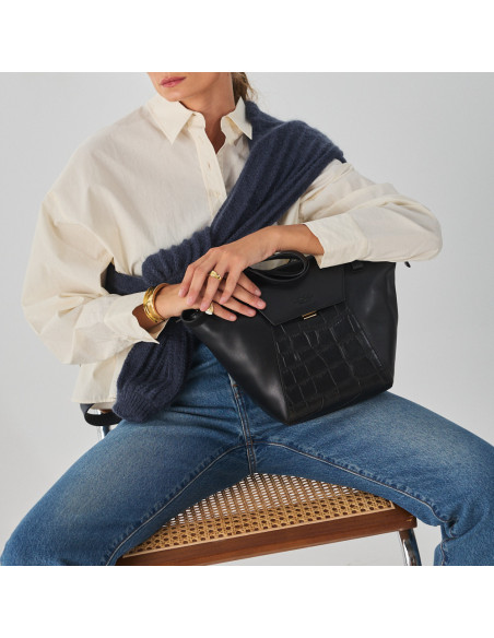 Black leather women's tote bag Paris Coco, perspective view, bag resting on the leg - MONPIEL