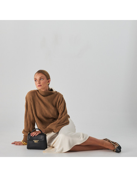 Animal print two-tone pointed-toe heeled leather flat, model sitting on the floor resting on a leather bag - MONPIEL