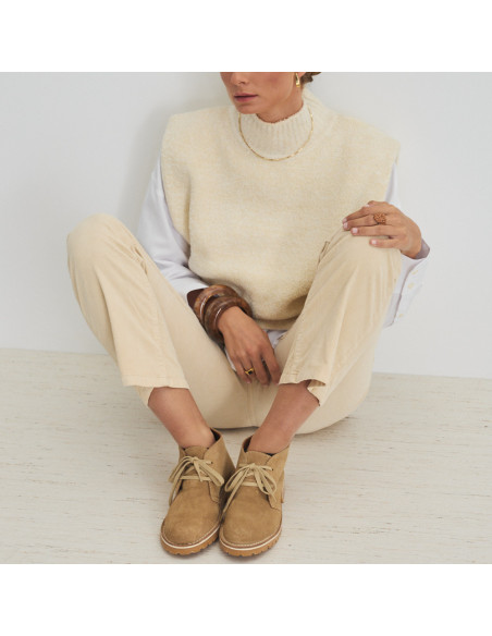 Heidi sand-colored leather ankle boot, front view, model sitting against the wall - MONPIEL