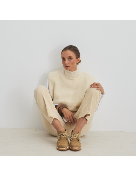 Heidi sand-colored leather ankle boot, front view, wide shot of model sitting - MONPIEL