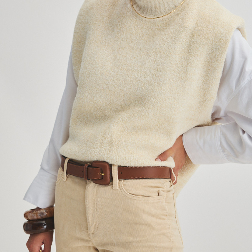 Women's leather belt with brown lined buckle, worn over corduroy trousers with perspective view and foot model - MONPIEL
