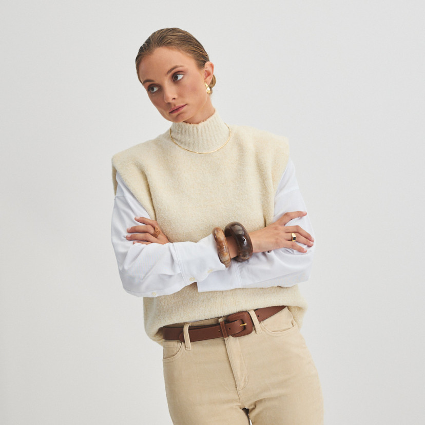 Women's leather belt with brown lined buckle, worn over corduroy trousers with front and general view, standing model - MONPIEL