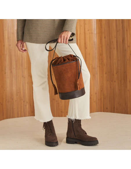 Round cube-shaped leather bag in suede leather colour, held with the hand, front view - MONPIEL