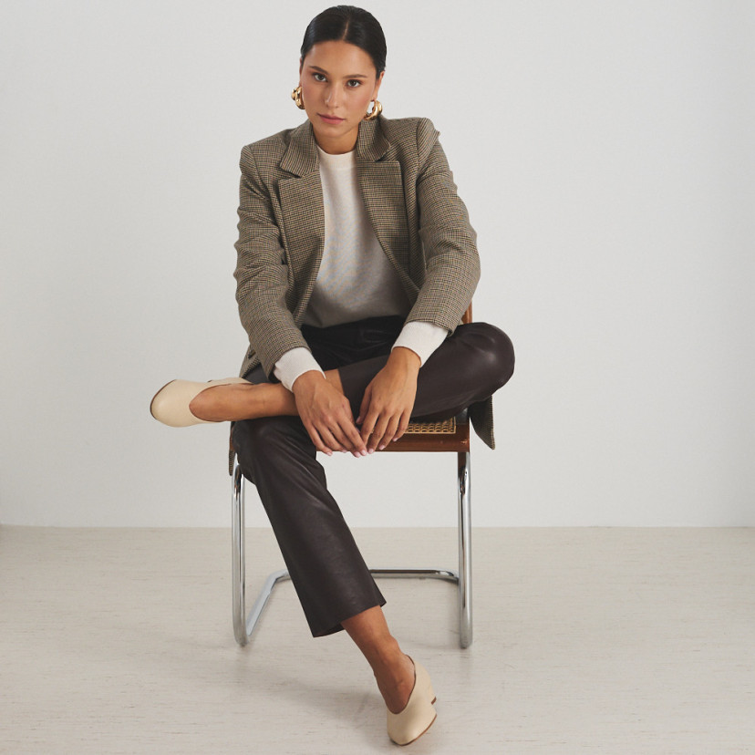 Beige heeled ballerina with model sitting on a chair, front view and wide shot - MONPIEL