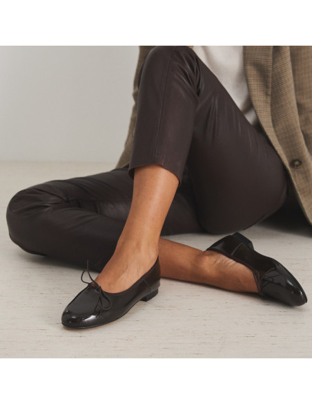 High front ballerina in brown patent leather, model sitting on the floor in close-up - MONPIEL High front ballerina in brown patent leather, model sitting on the floor in close-up - MONPIEL