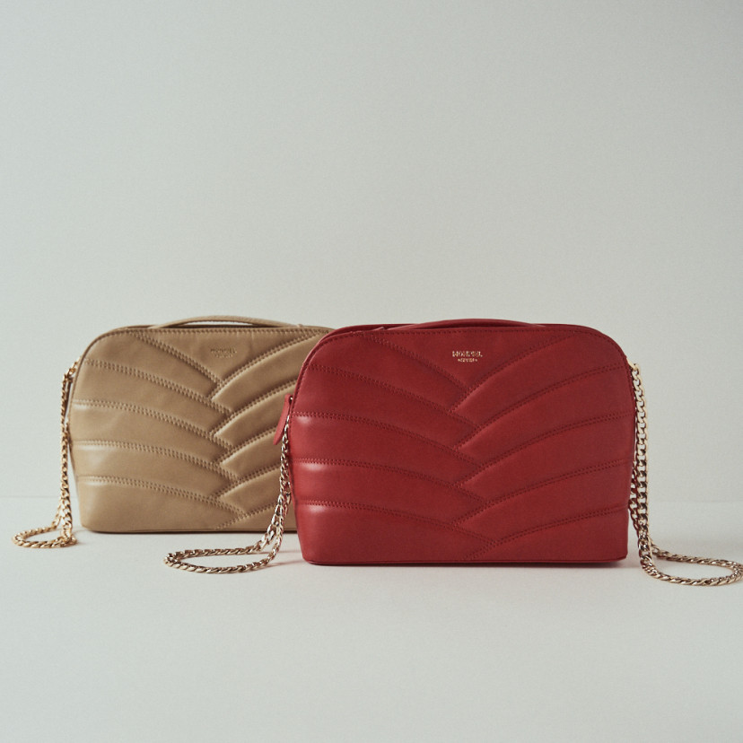 Quilted leather bag with gold chain in red, with a beige quilted bag behind - MONPIEL