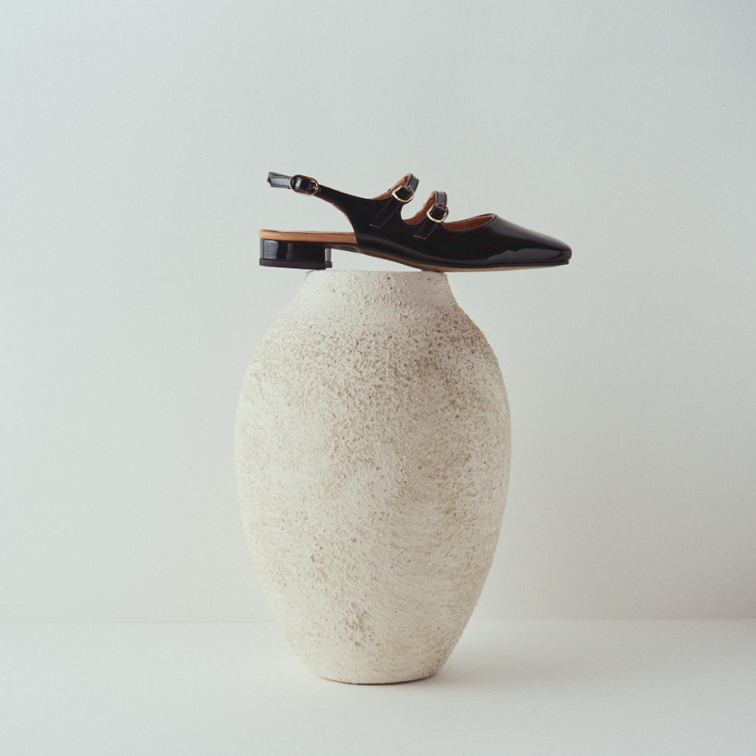 Lolina backless Mary Jane in black with side view on top of the vase - MONPIEL