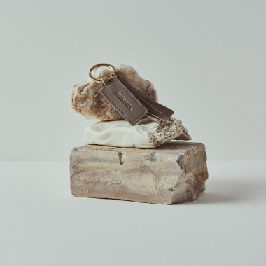 Leather tassel keychain in leather colour resting on rocks - MONPIEL 2