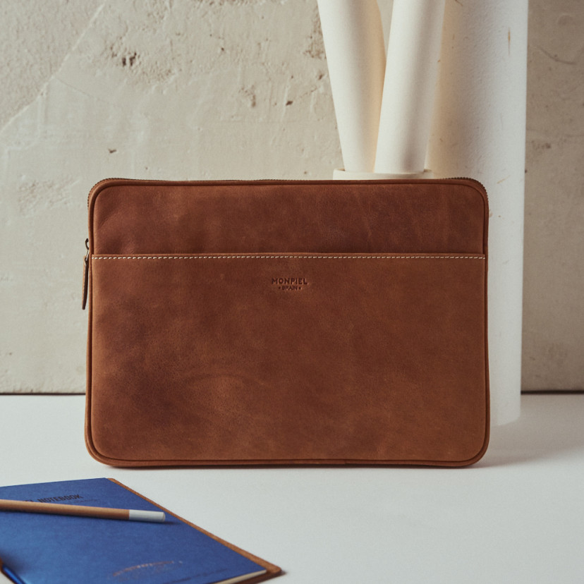 13" and 14"-inch leather laptop sleeve in leather color with front view resting on a vase - MONPIEL