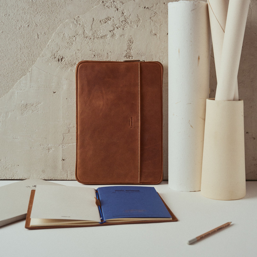 13" and 14"-inch leather laptop sleeve in leather color with front view placed vertically resting against the wall - MONPIEL