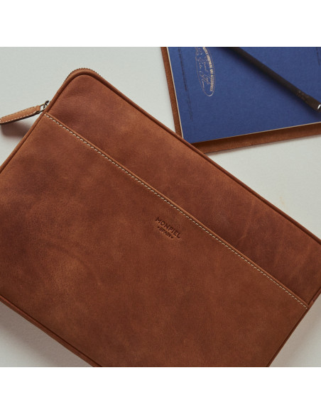 15"-inch leather laptop sleeve in tan, resting on a table, top view - MONPIEL