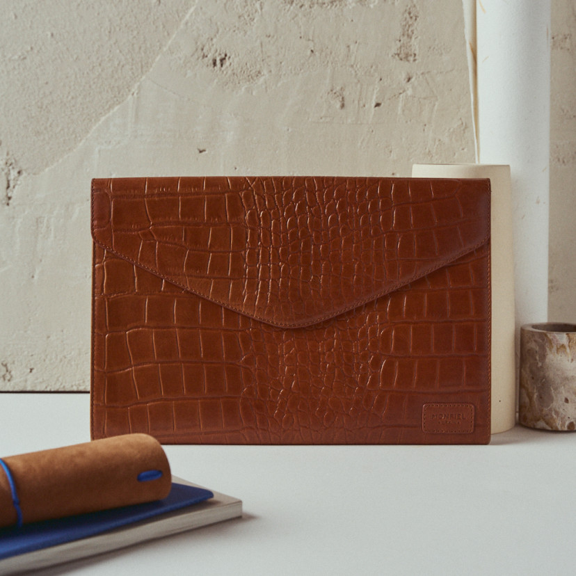 Elegance coco leather laptop sleeve in leather colour with front view resting on a vase - MONPIEL