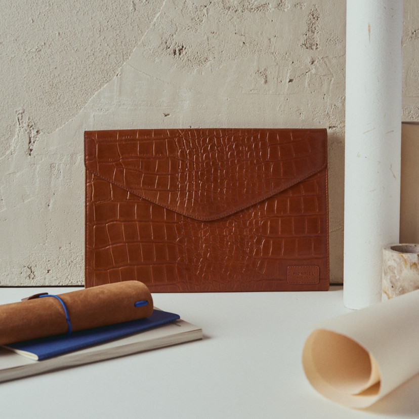 Elegance coco leather laptop sleeve in leather colour with front view resting on the wall - MONPIEL