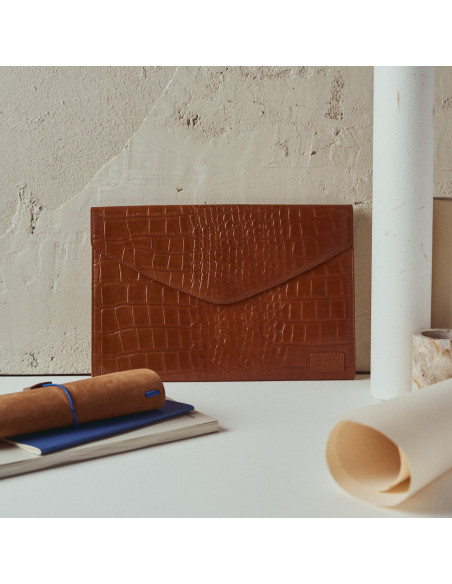 Elegance Coco leather laptop sleeve in tan, front view, leaning against a wall - MONPIEL