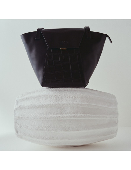 Black leather tote bag Paris Coco, front view, placed atop a vase - MONPIEL