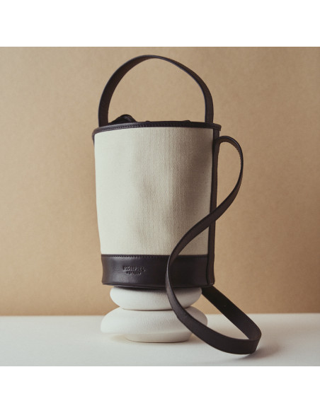 Small black canvas cube bag resting on decoration - MONPIEL