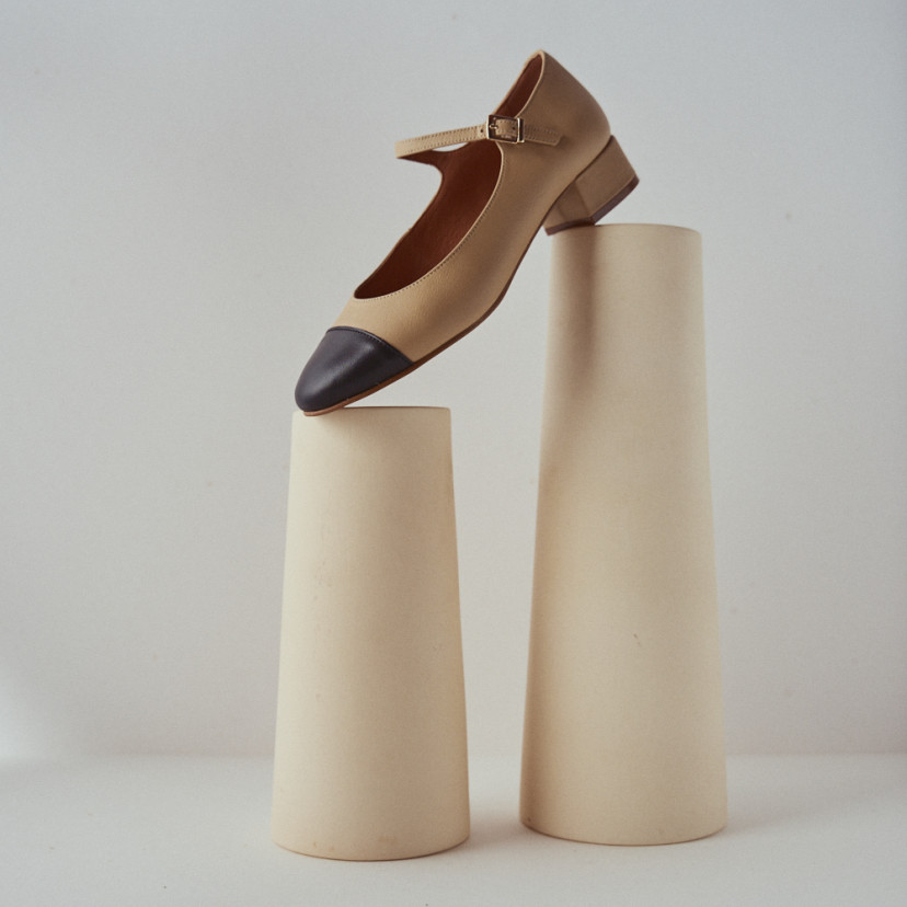 Charlotte toe-cap Mary Jane in beige with side view resting on two vases - MONPIEL