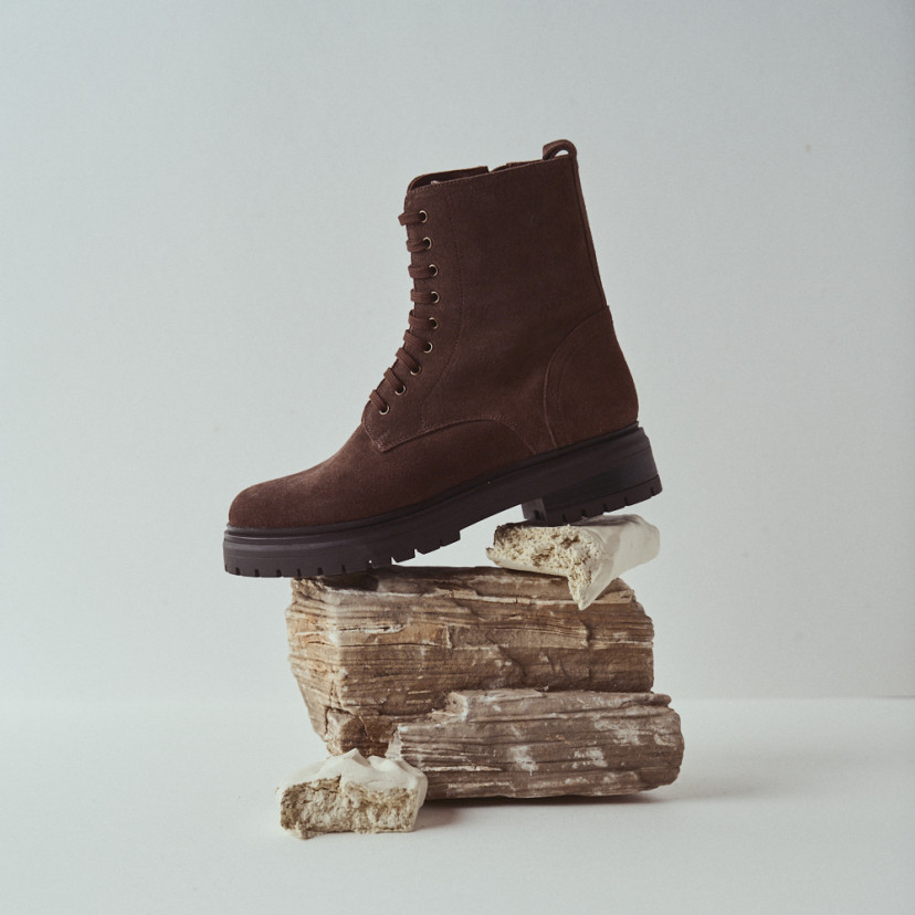 Camila lace-up boot in brown suede with side view resting on wood - MONPIEL