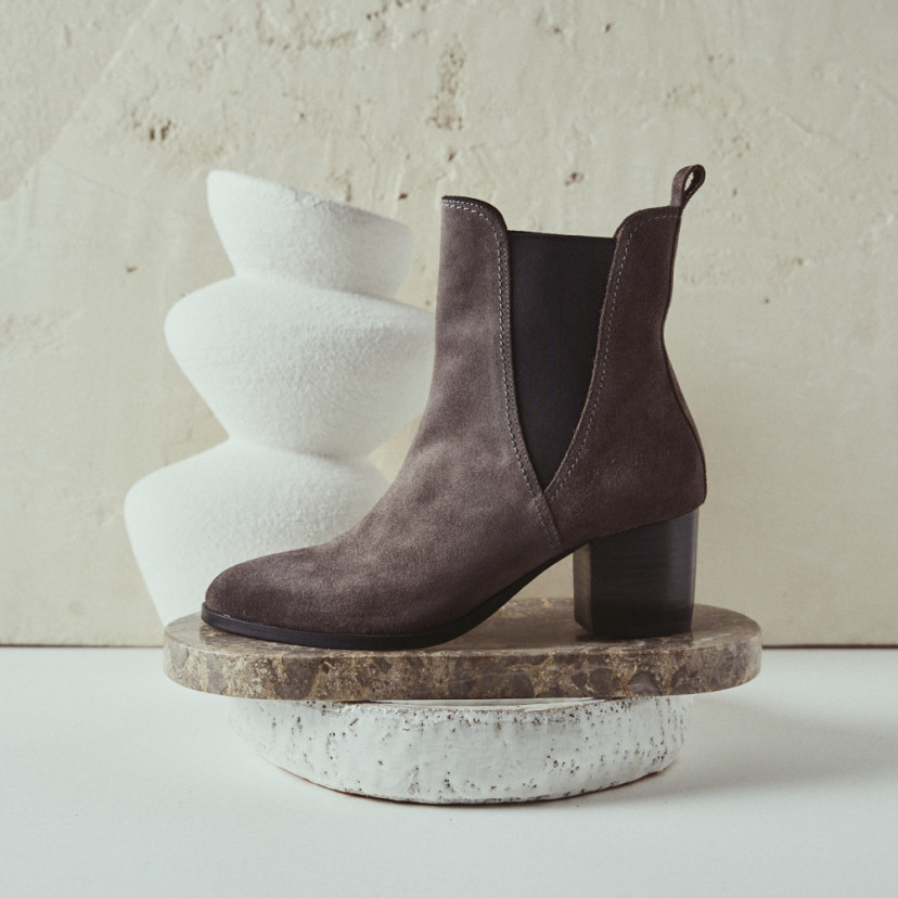 Marcela leather boot in gray suede with side view resting on marble - MONPIEL