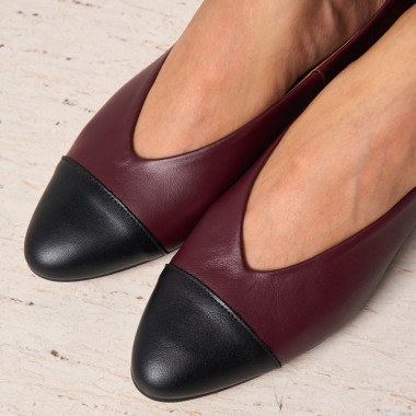 Beige leather ballerina with bicolor toe and heel, angled view, resting on marble - MONPIEL 2