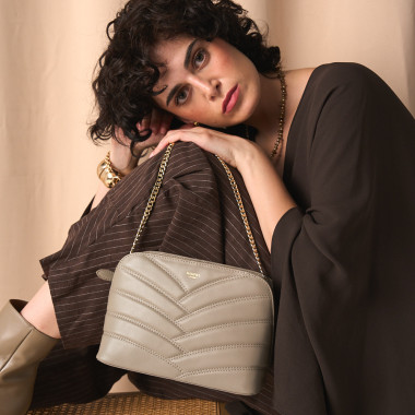 Tan quilted leather bag with a gold chain, next to soaps - MONPIEL 2