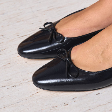 Ballerine Manolita à bout stylisé en noir, vue en perspective, posée sur une pierre en gros plan - MONPIEL 2