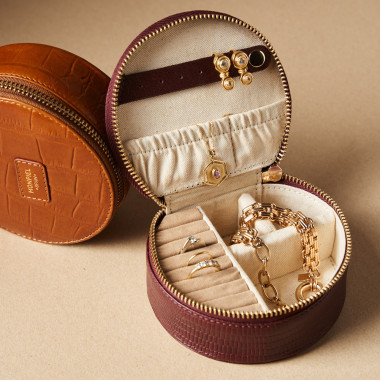 Burgundy snakeskin leather jewelry box open with jewelry inside, next to a jewelry box in tan croc-embossed leather - MONPIEL 2