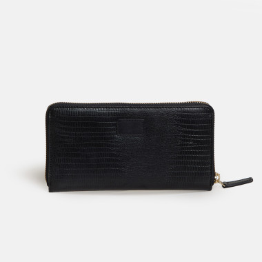 Women’s leather wallet with zipper in leather color, perspective view resting on a vase - MONPIEL 2