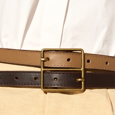 Two-tone leopard and leather belt with double buckle on denim in close-up - MONPIEL 2